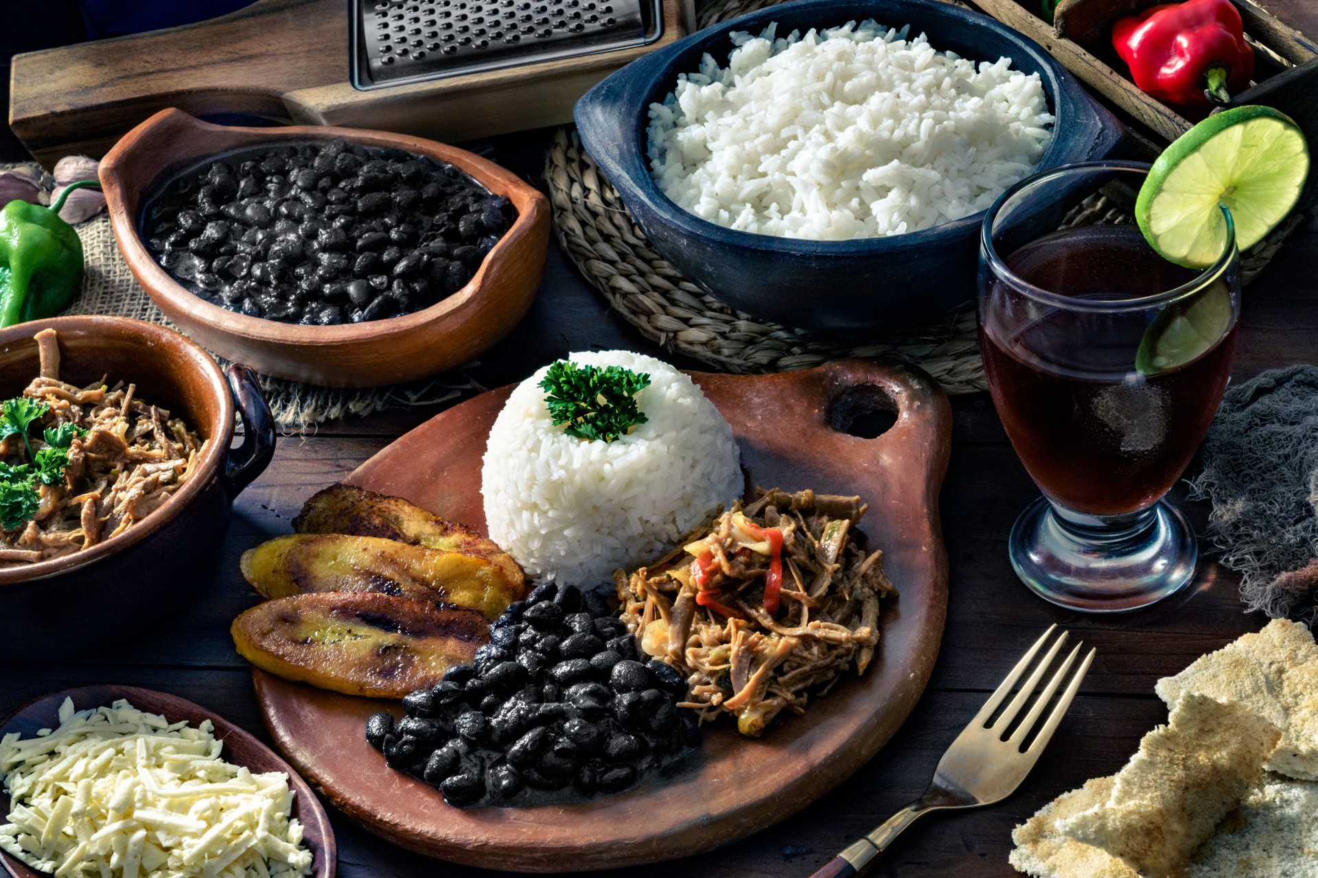 Venezuelan traditional food, Pabellon Criollo with arepas, casabe and papelon with lemon drink